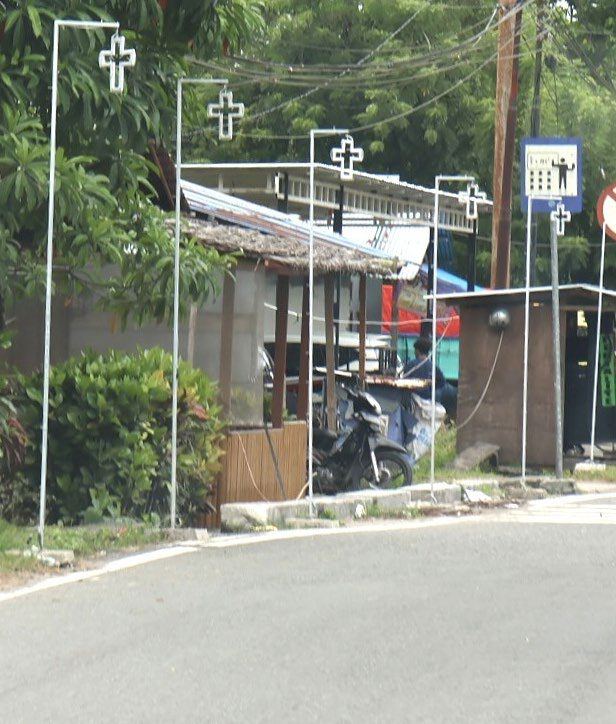 A village street with crosses mounted on lamp posts