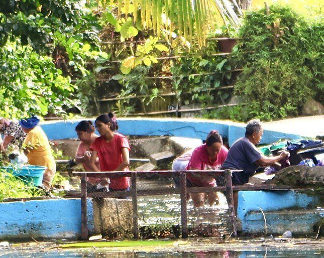 Villagers washing at a communal pool